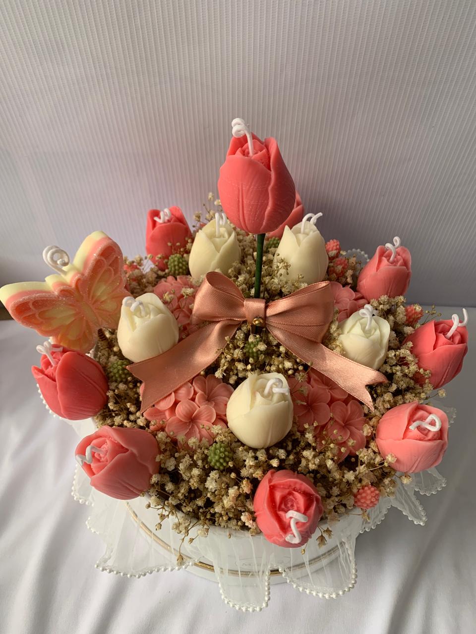 Arreglo de flores en velas rosadas